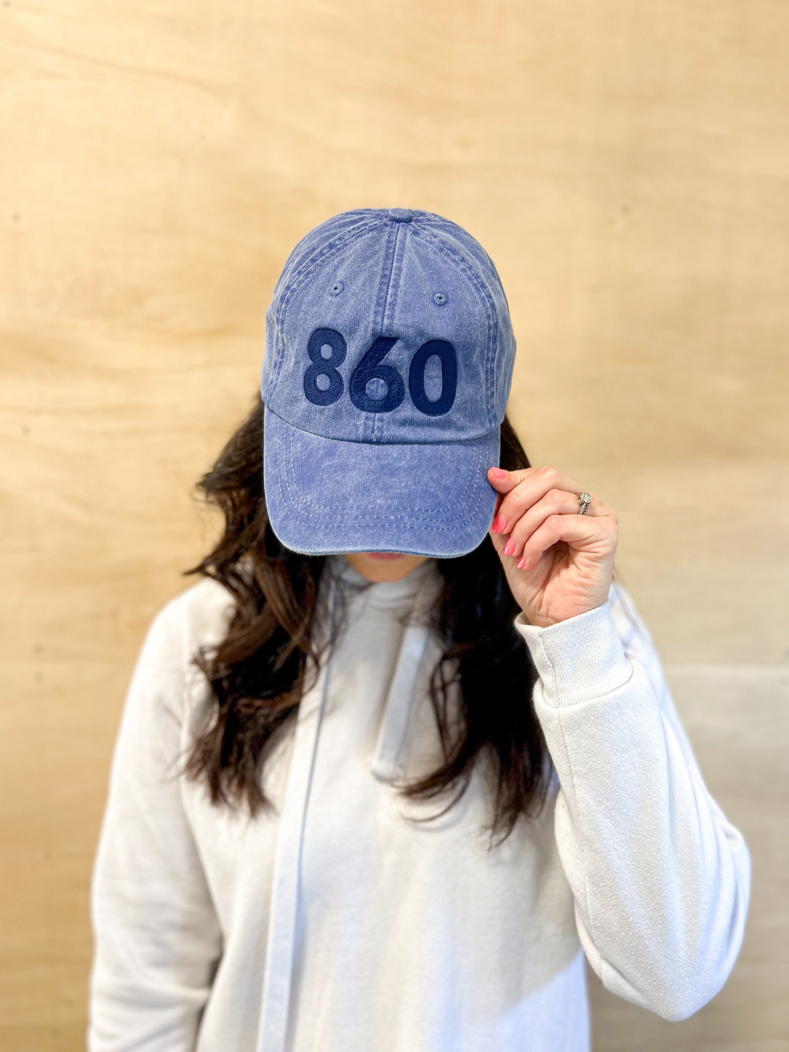Blue baseball cap with blue 860 embroidered on the front, blue anchored american embroidered on the back leather adjustment strap