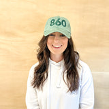 Green baseball cap with green 860 embroidered on the front, and a green anchored American embroidered on the back.