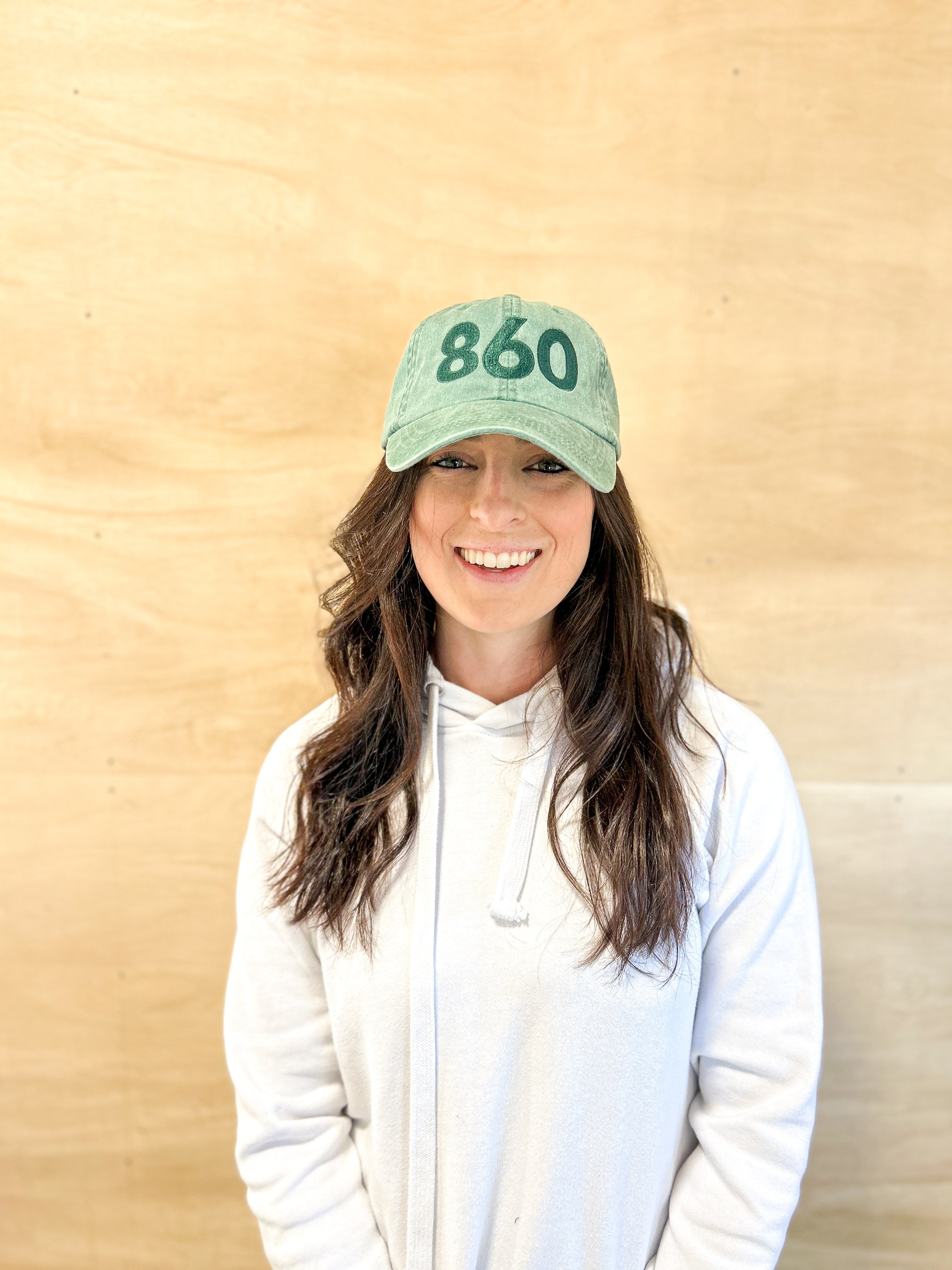 Green baseball cap with green 860 embroidered on the front, and a green anchored American embroidered on the back.