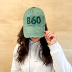Green baseball cap with green 860 embroidered on the front, and a green anchored American embroidered on the back.