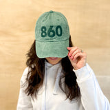Green baseball cap with green 860 embroidered on the front, and a green anchored American embroidered on the back.