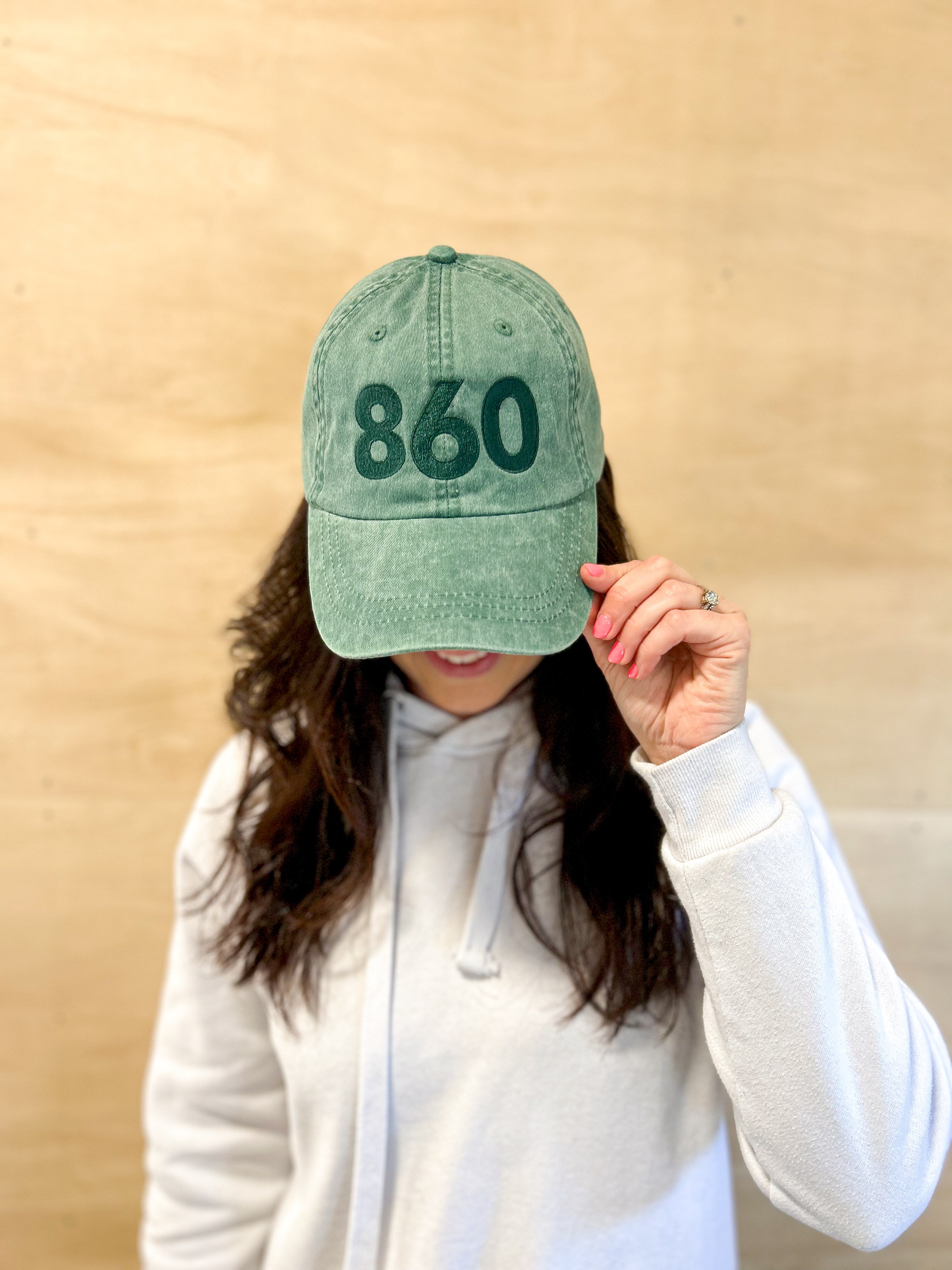 Green baseball cap with green 860 embroidered on the front, and a green anchored American embroidered on the back.
