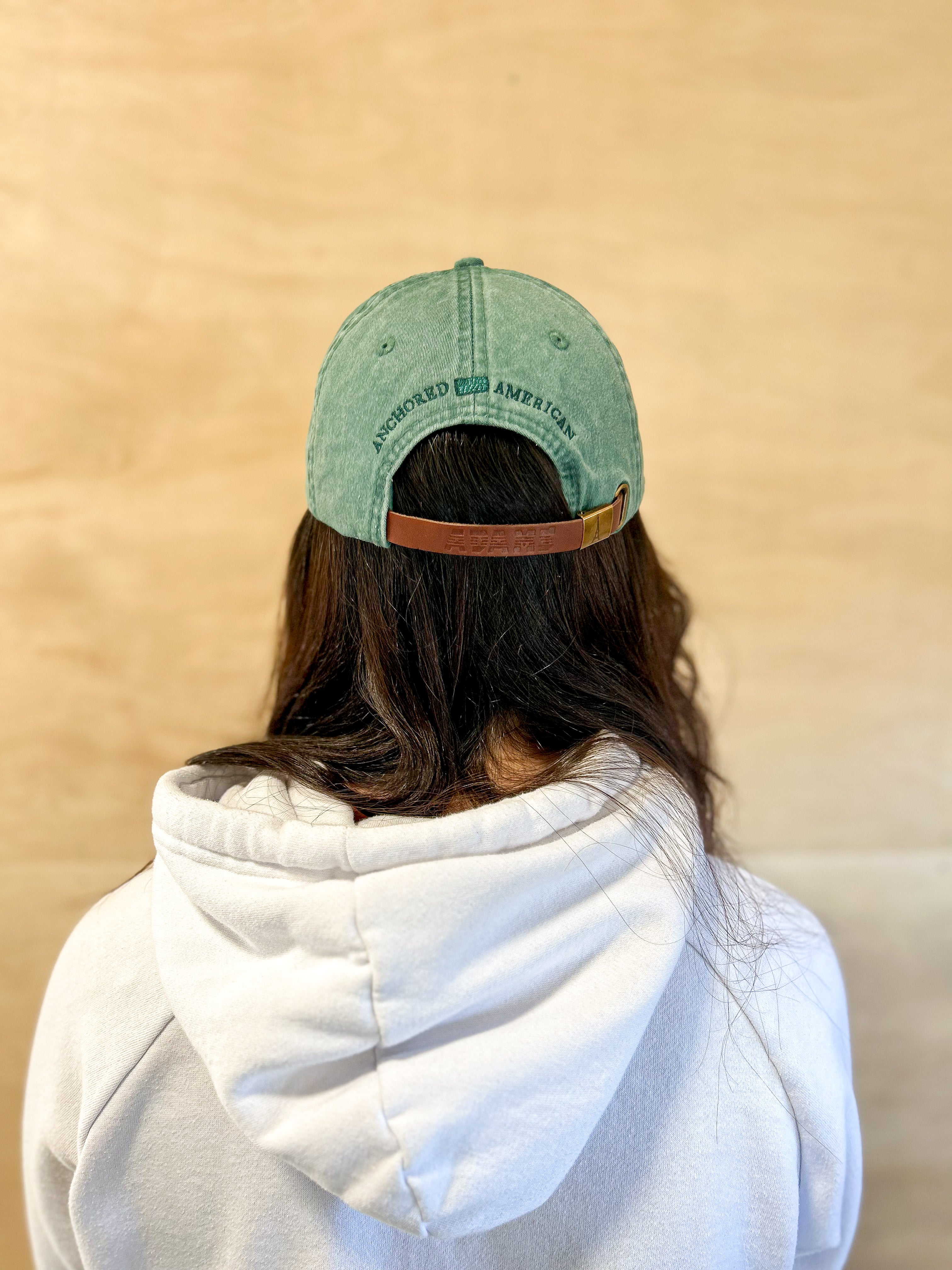Green baseball cap with green 860 embroidered on the front, and a green anchored American embroidered on the back.