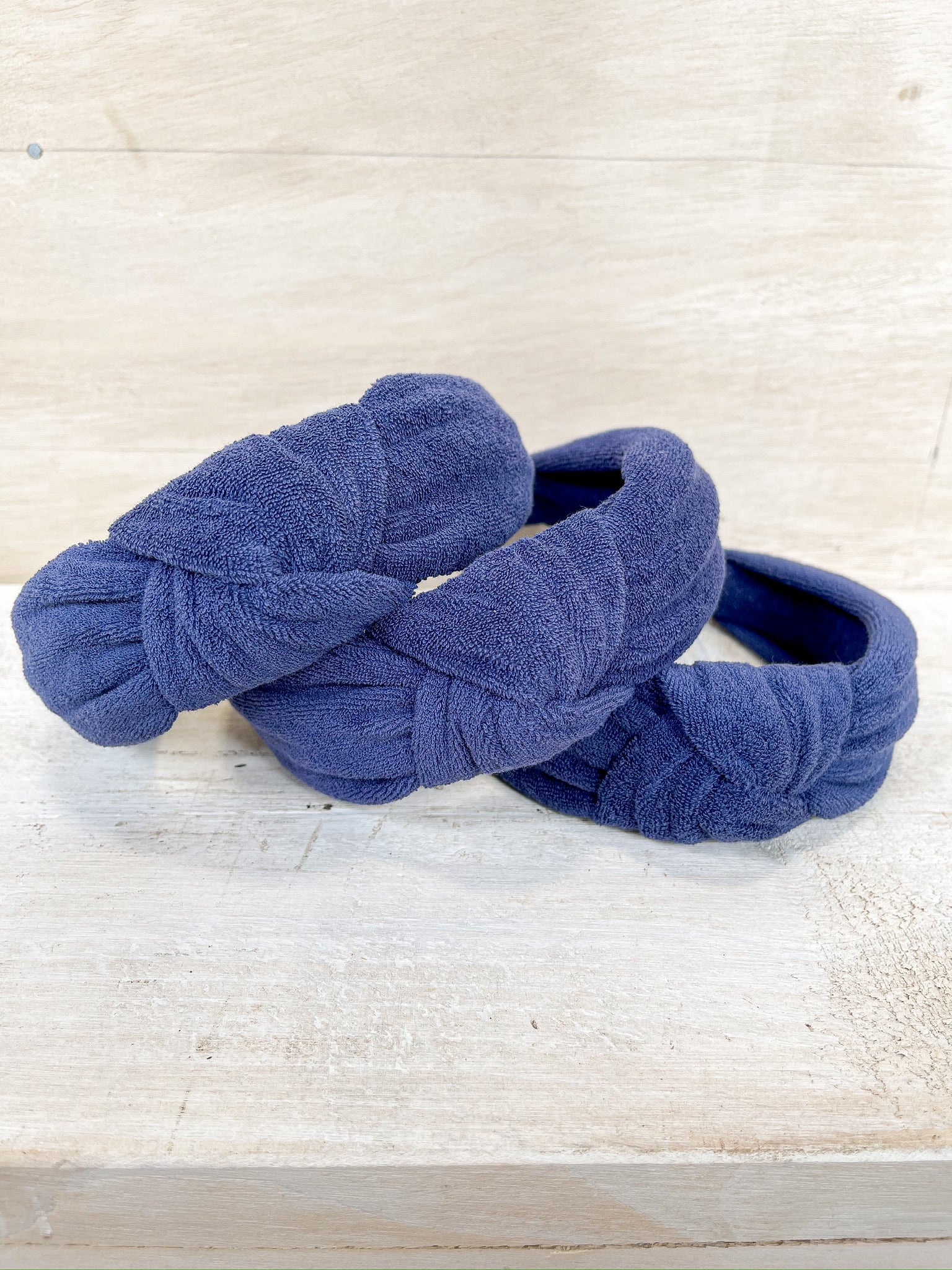 blue terry cloth material, knot detail on headband, one size