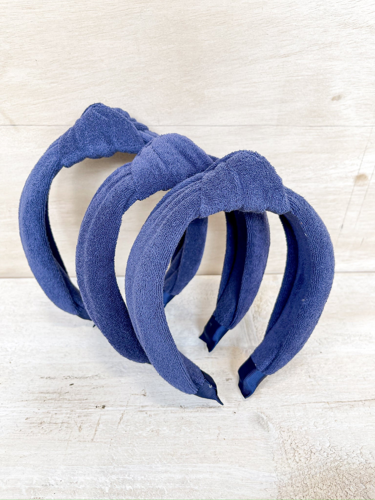 blue terry cloth material, knot detail on headband, one size