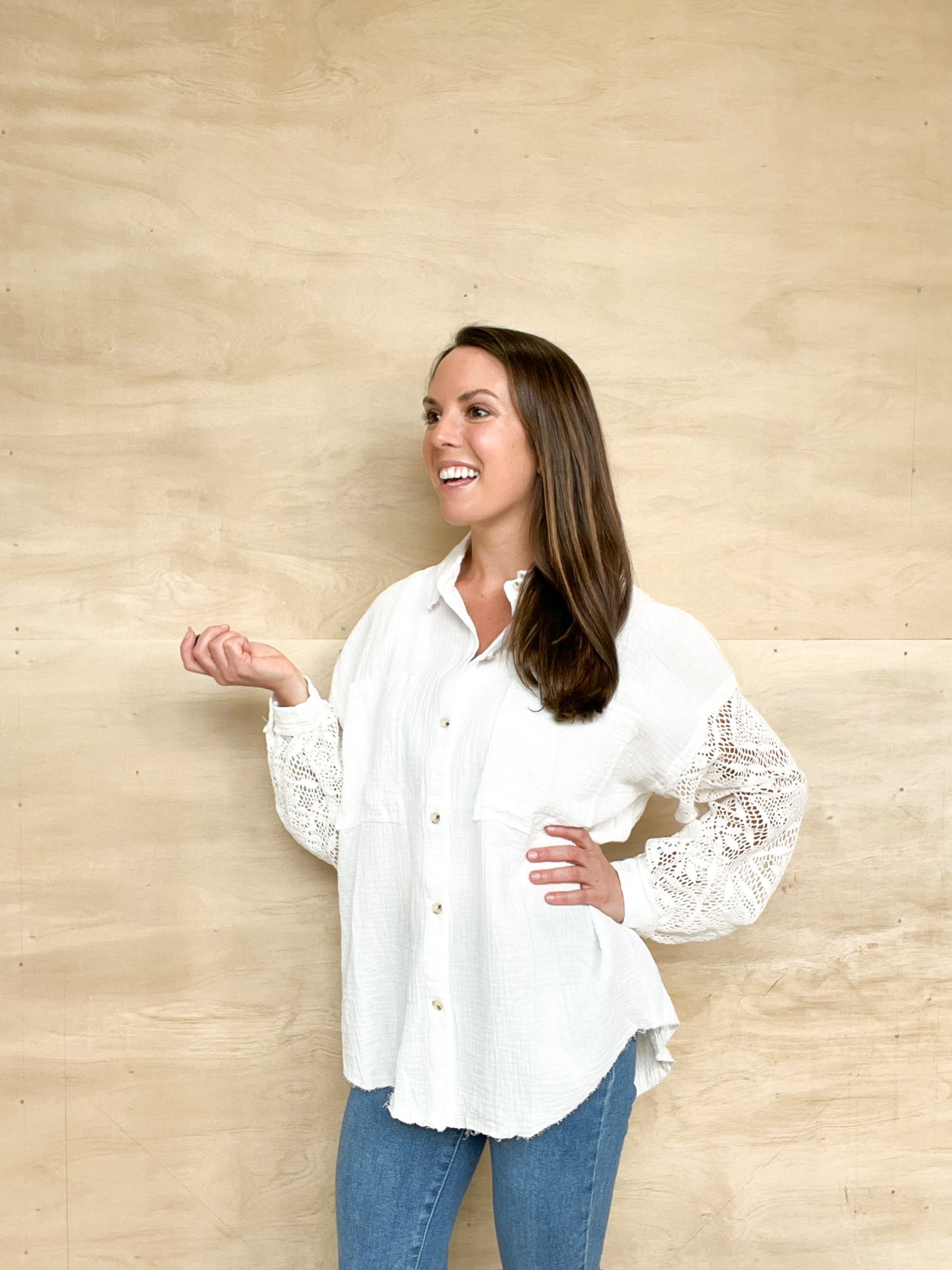 Long sleeve white gauze button up, crochet detail on the sleeve, tortoise shell button, collared top, oversized fit in the body, frayed edges on the bottom.