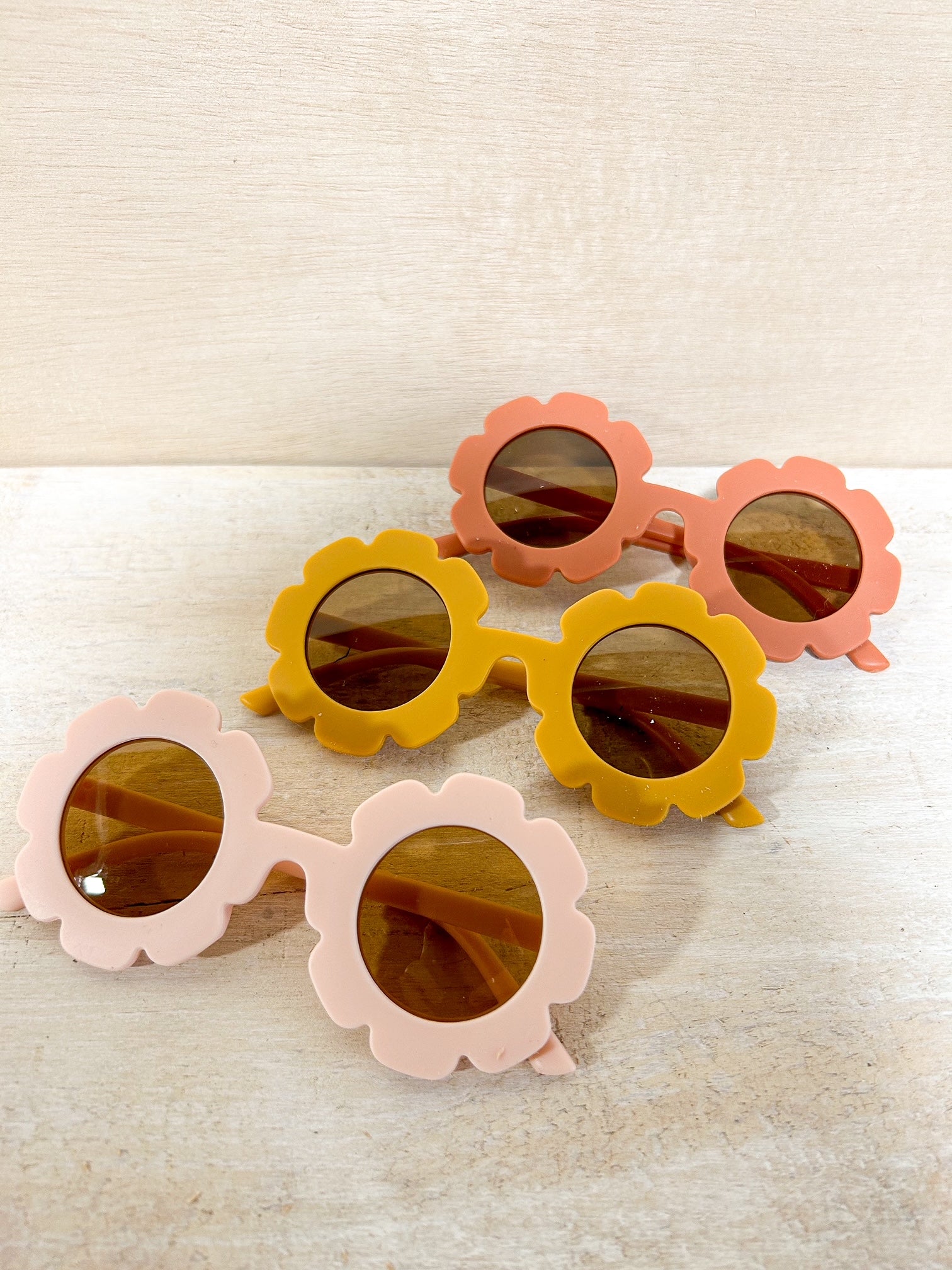 Kids floral sunglasses in pink, yellow, and red