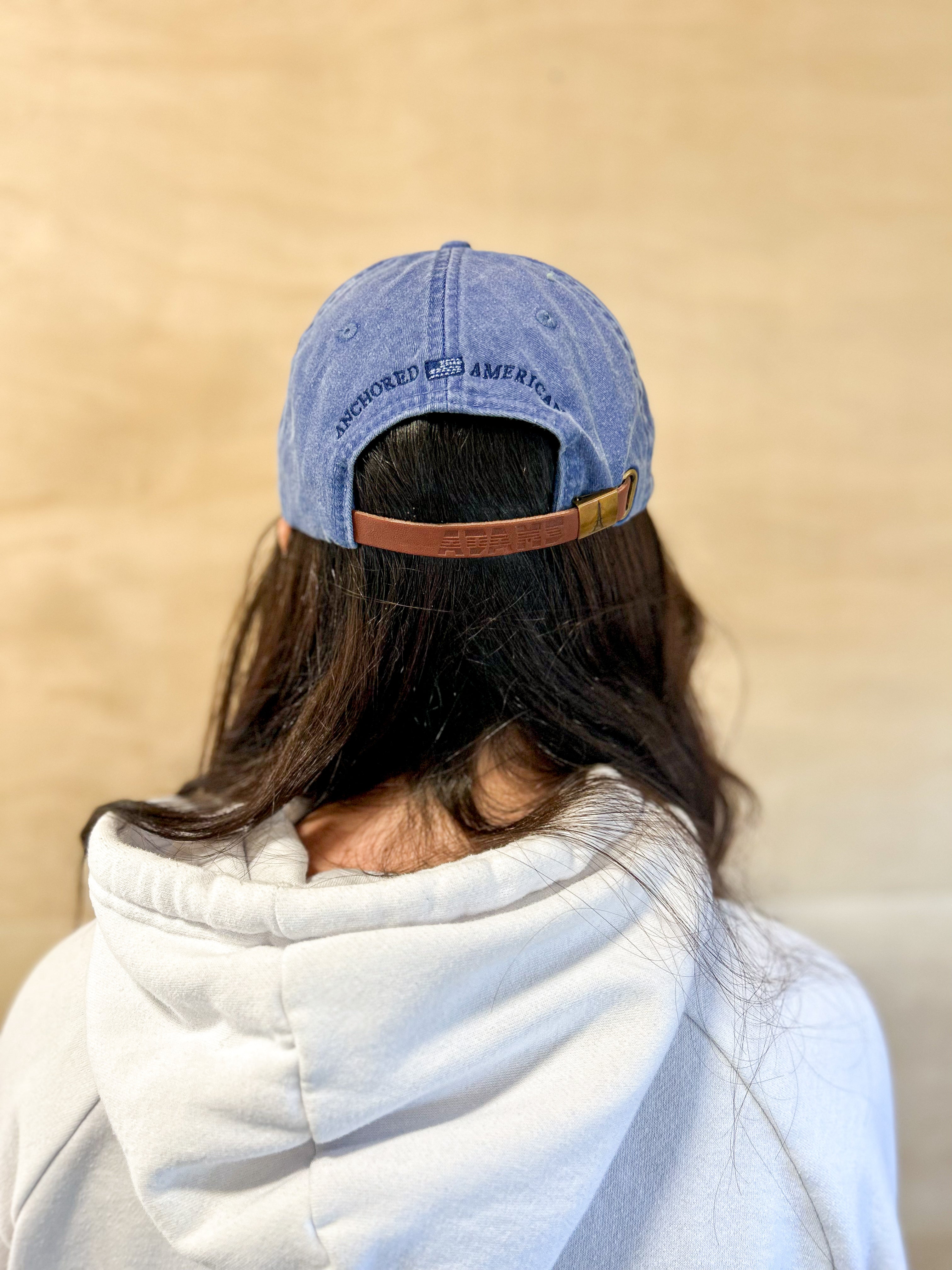 Blue baseball cap with blue 860 embroidered on the front, blue anchored american embroidered on the back leather adjustment strap