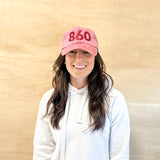 Red baseball cap, red 860 embroidered on the front, red Anchored American embroidered on the back, leather adjustment strap