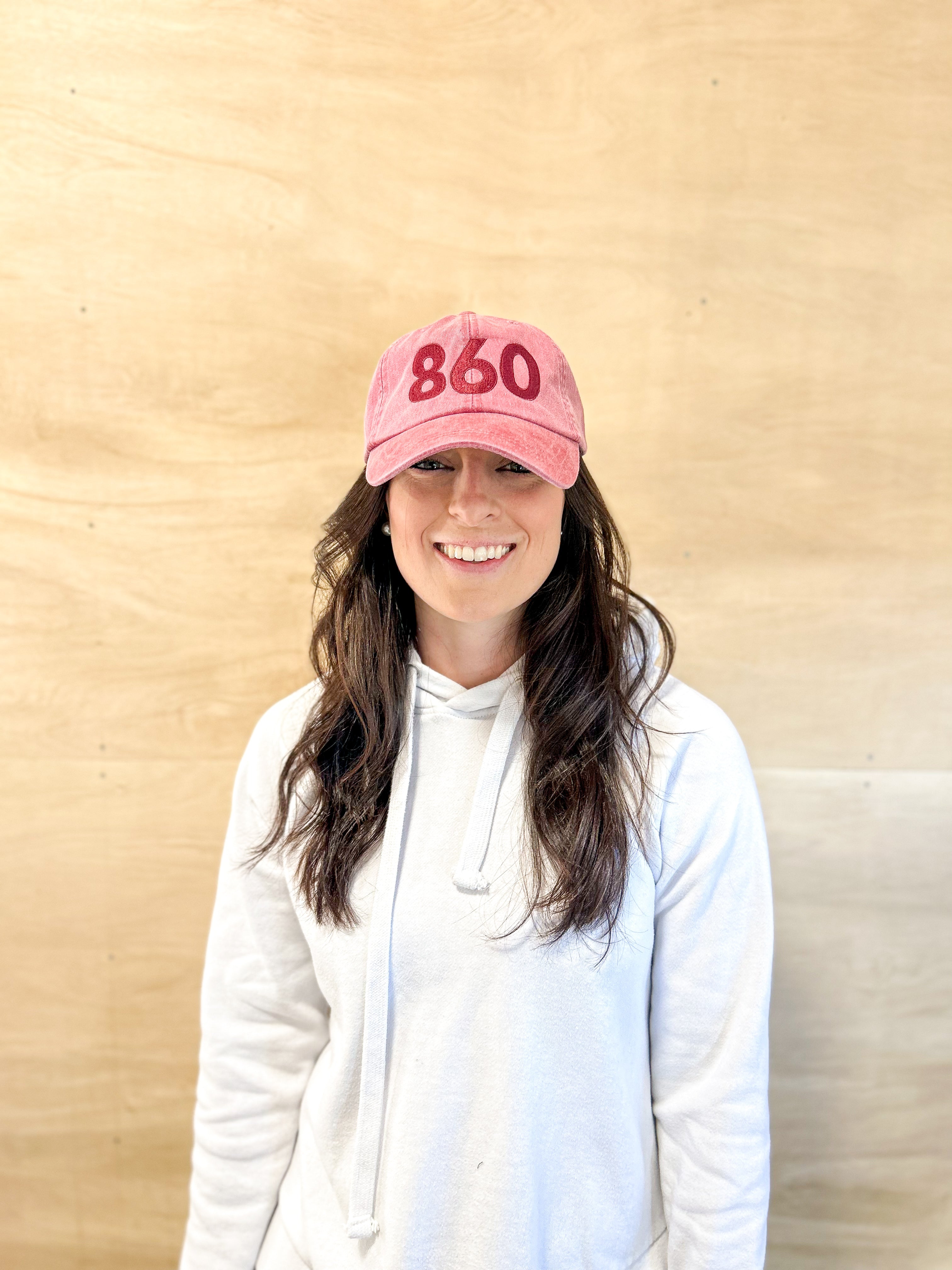 Red baseball cap, red 860 embroidered on the front, red Anchored American embroidered on the back, leather adjustment strap