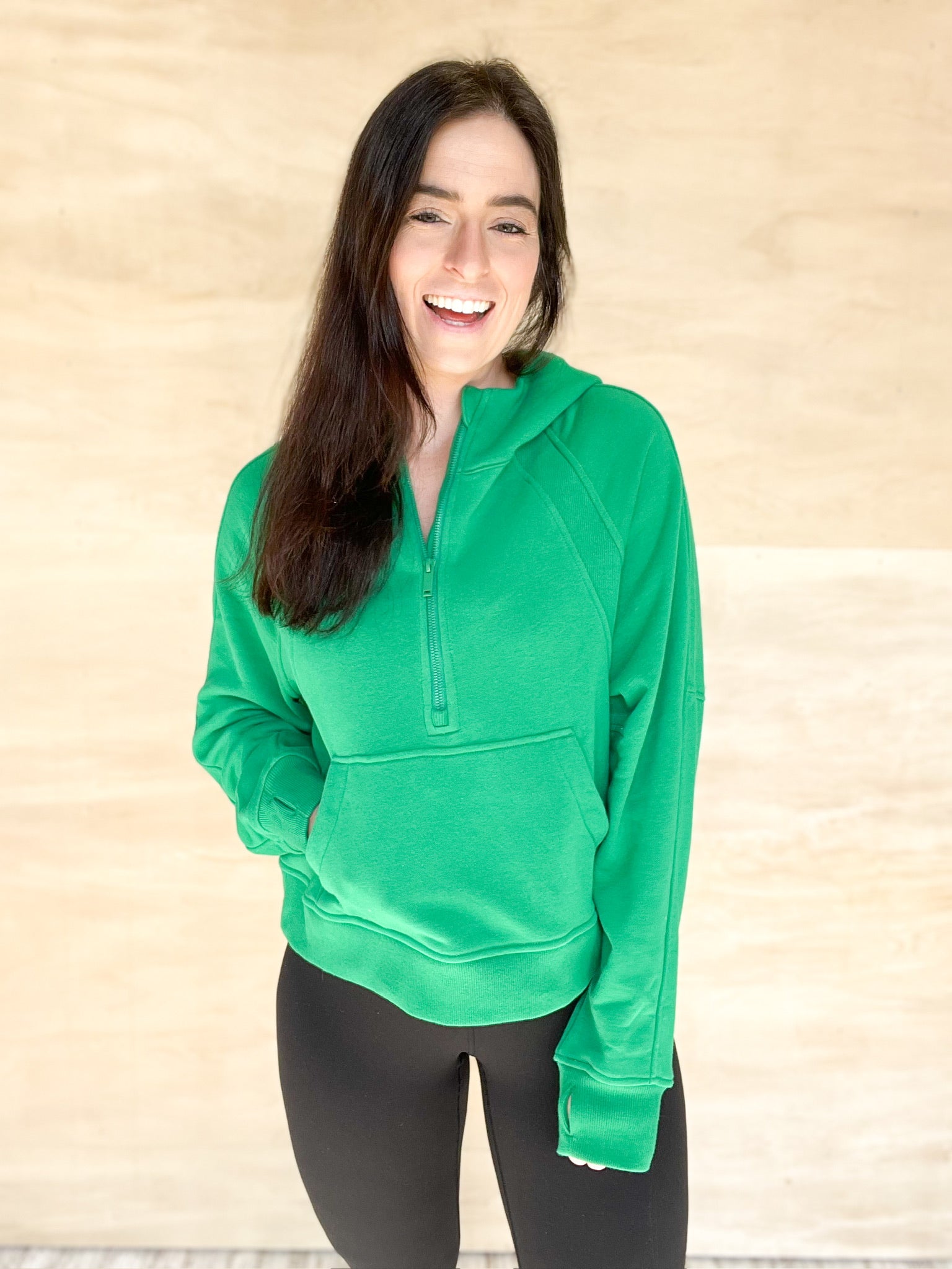Green quarter zip sweatshirt, large front pocked, cropped in length, thumb holes on sleeve, hood