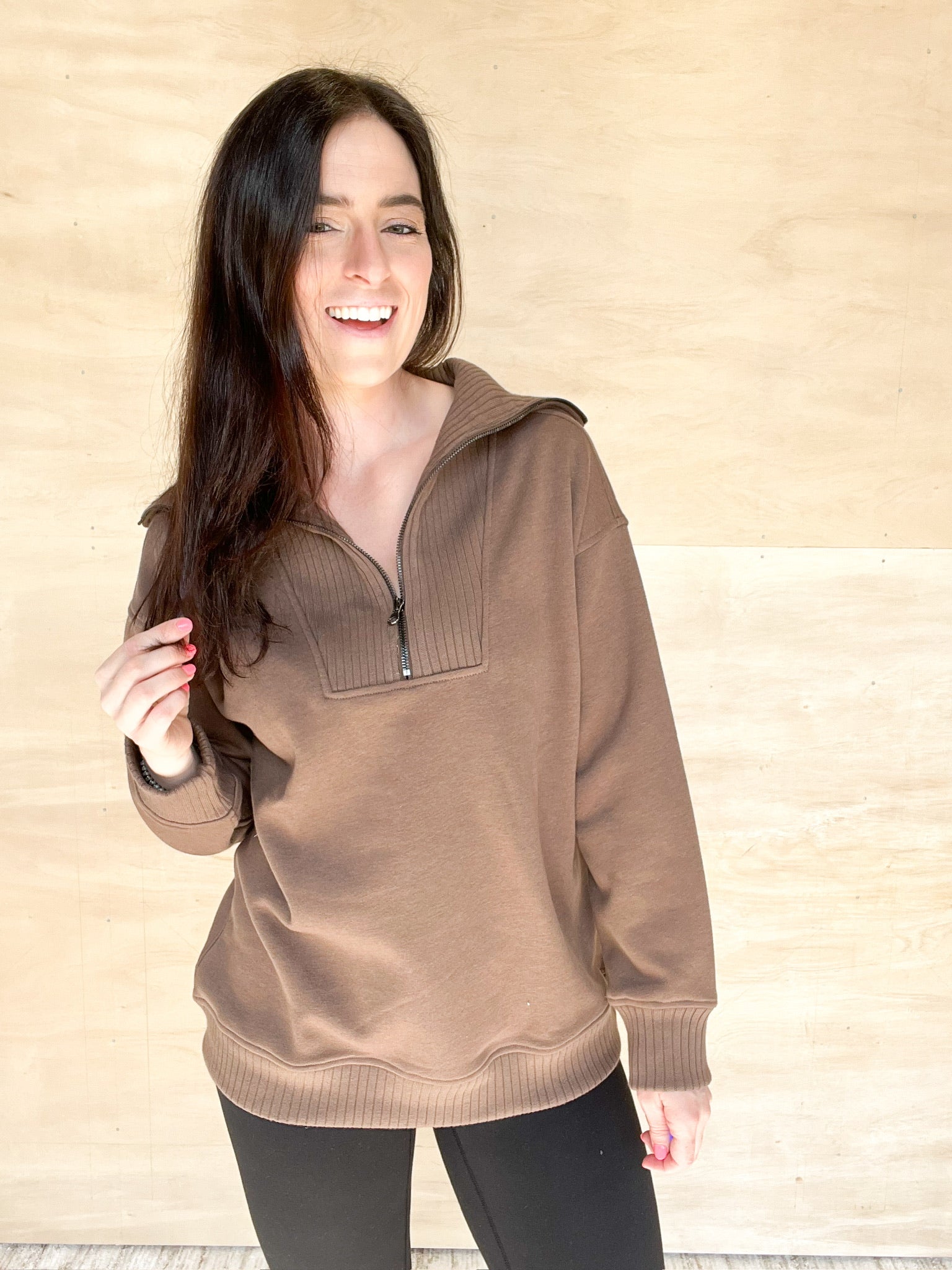 Brown quarter zip sweatshirt,  ribbed material around the zipper and on the collar, ribbed waistband, long in length, oversized fit in the body