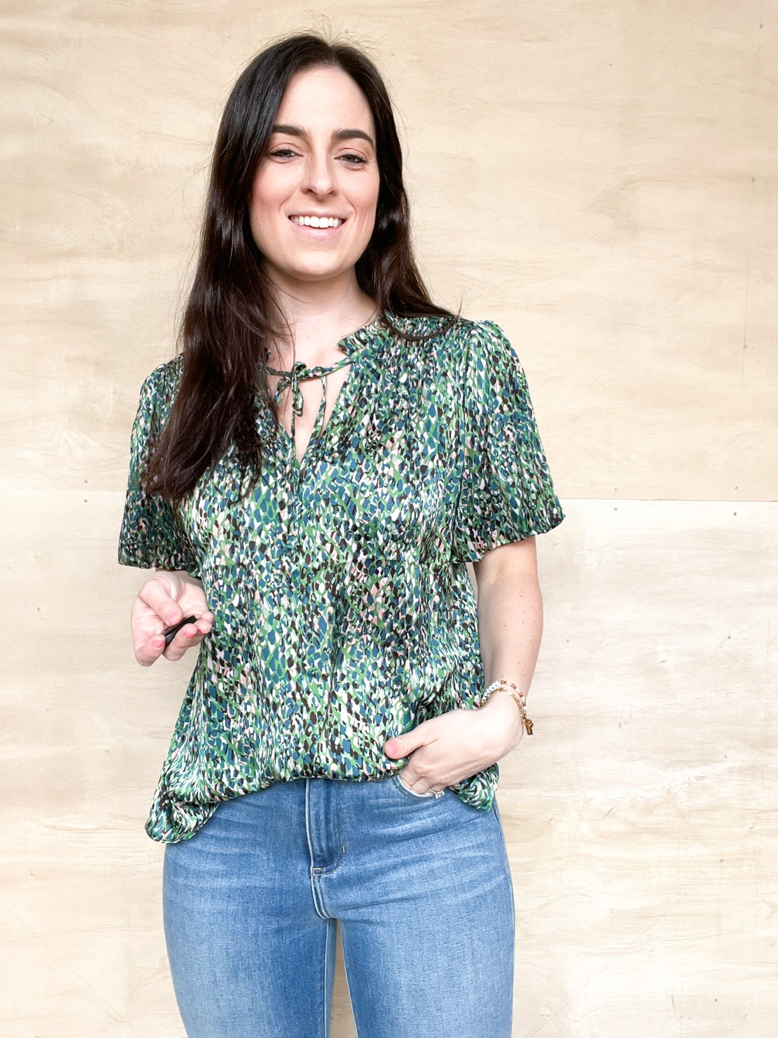 Short sleeve flowy blouse, green marbled coloring, frill neckline with a tie front, relaxed fitting in the body